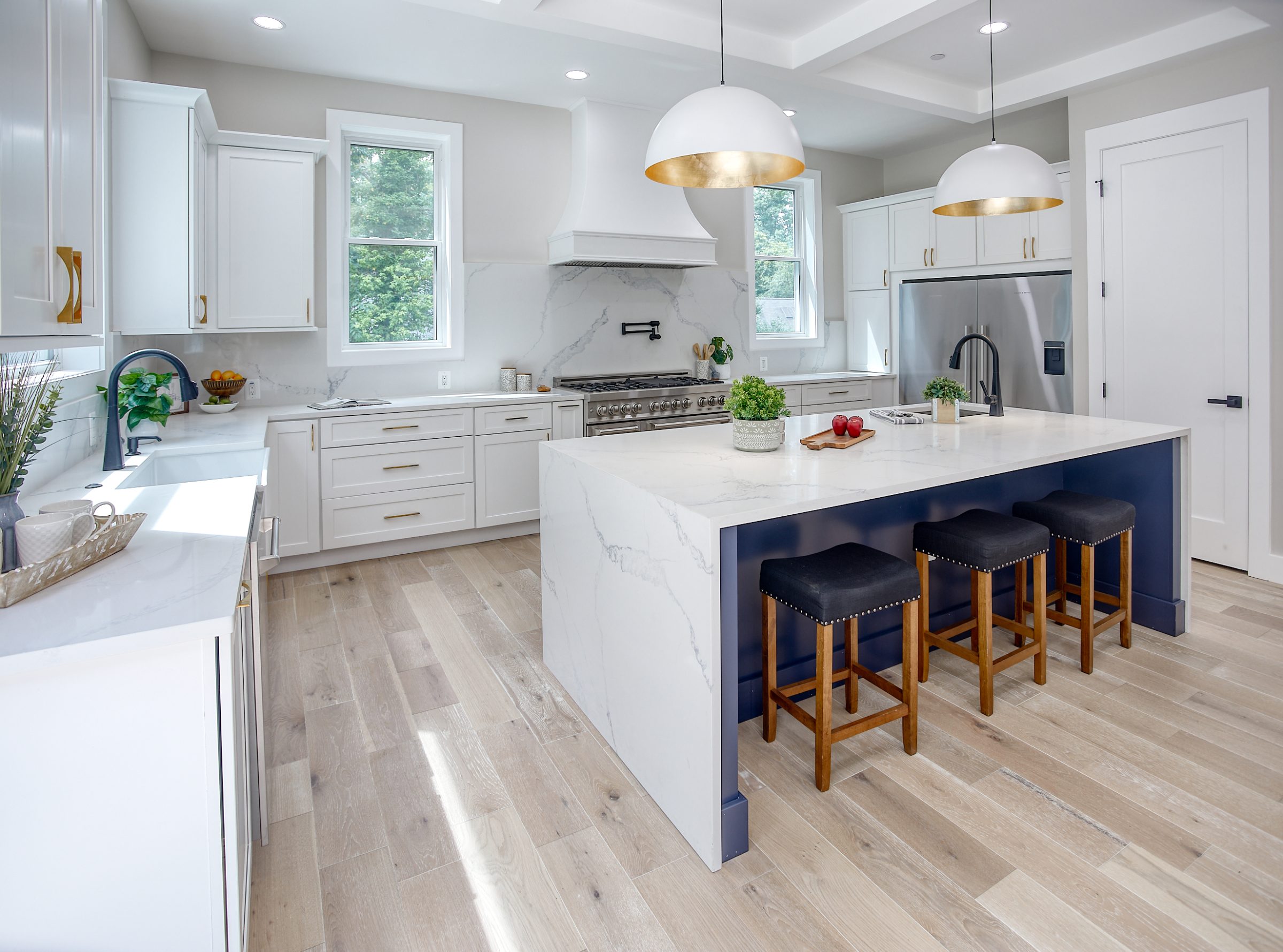 Bright kitchen with a marble waterfall island